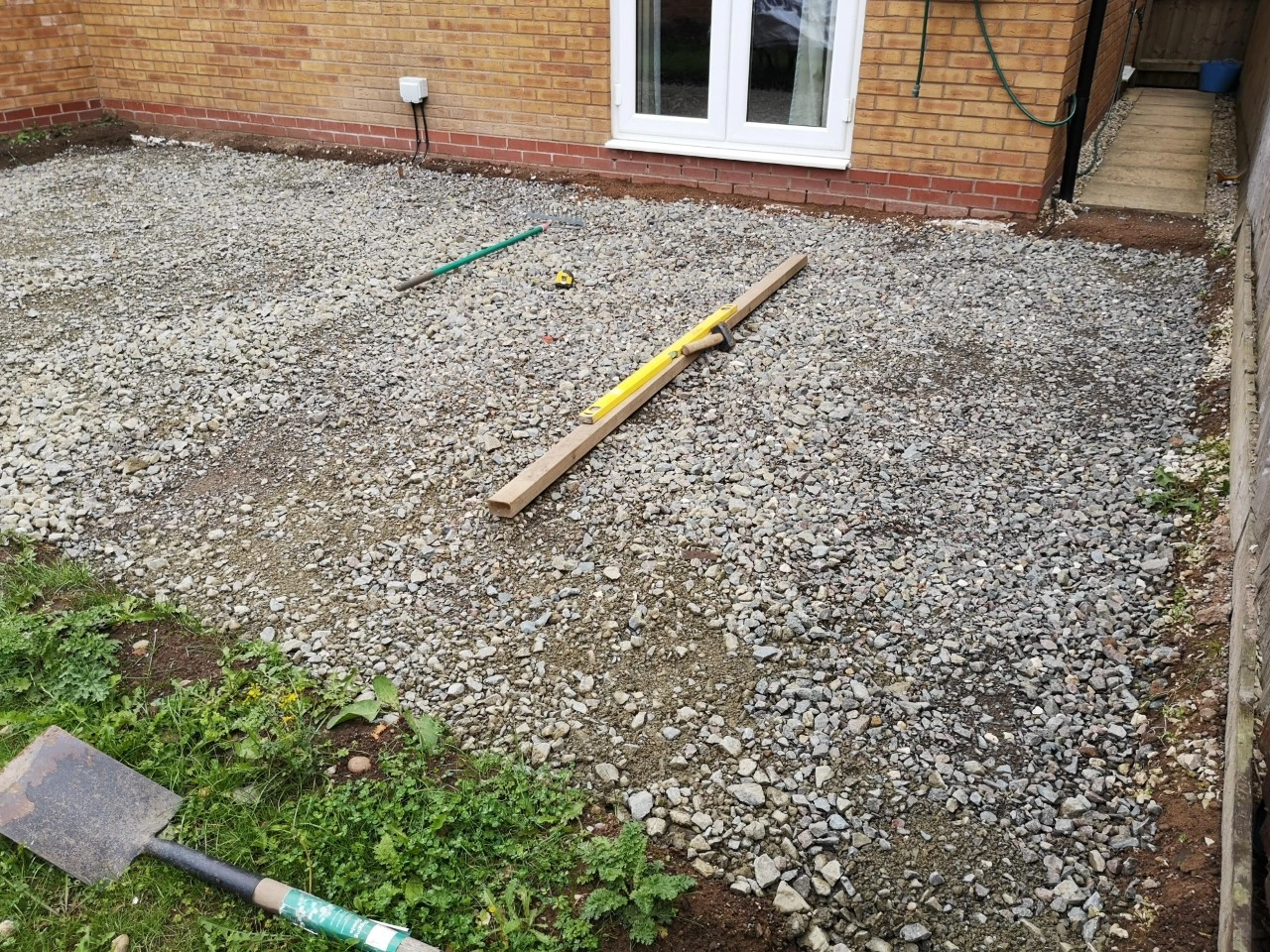 Sub base fitted over the startings of a patio being fitted in a garden.